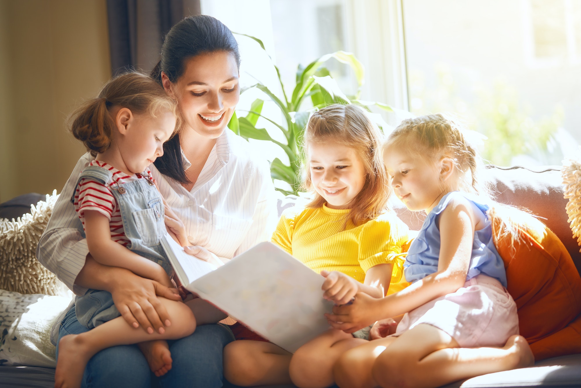 Mom and children reading a book