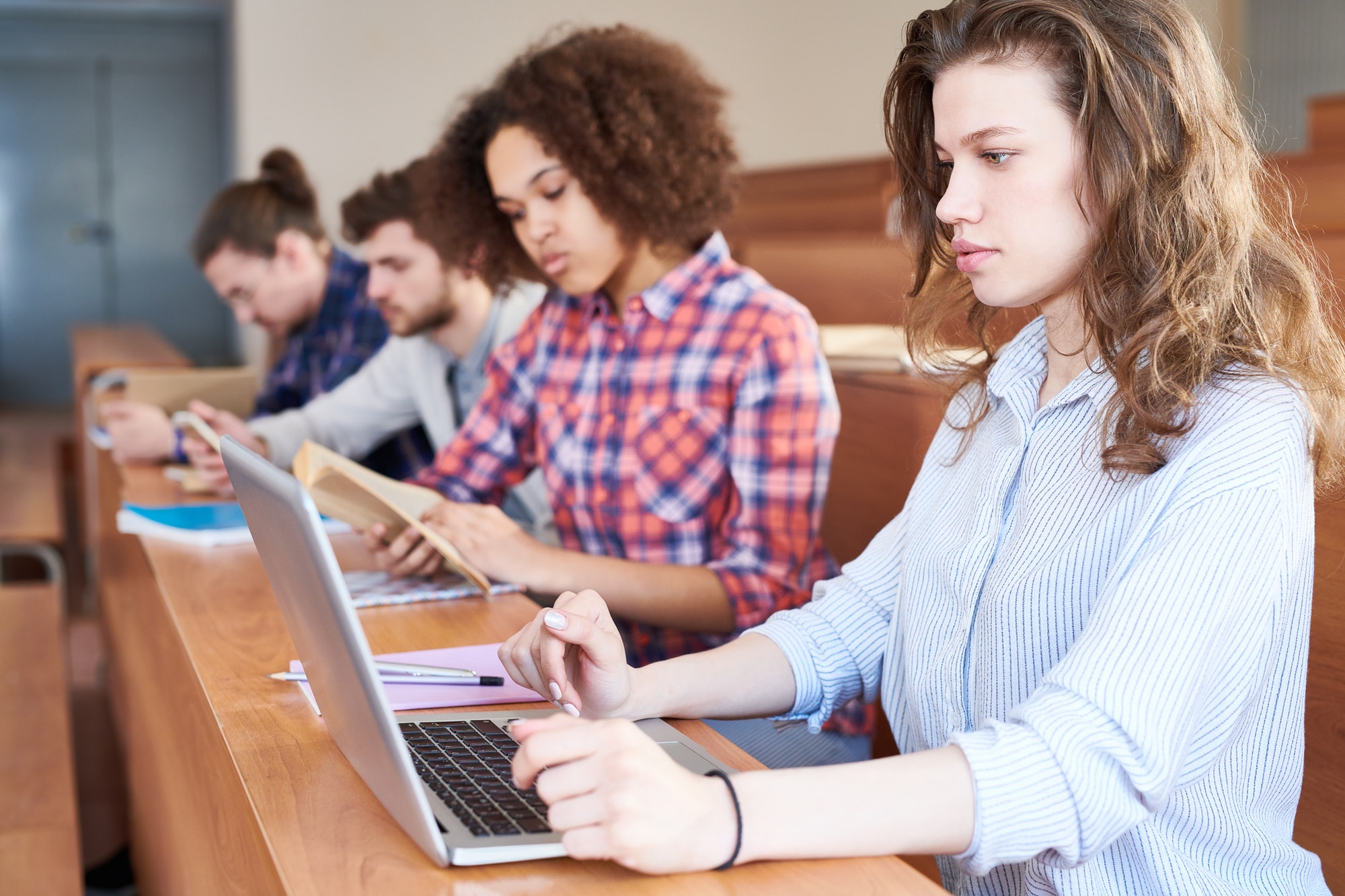 Concentrated university student preparing for test with laptop