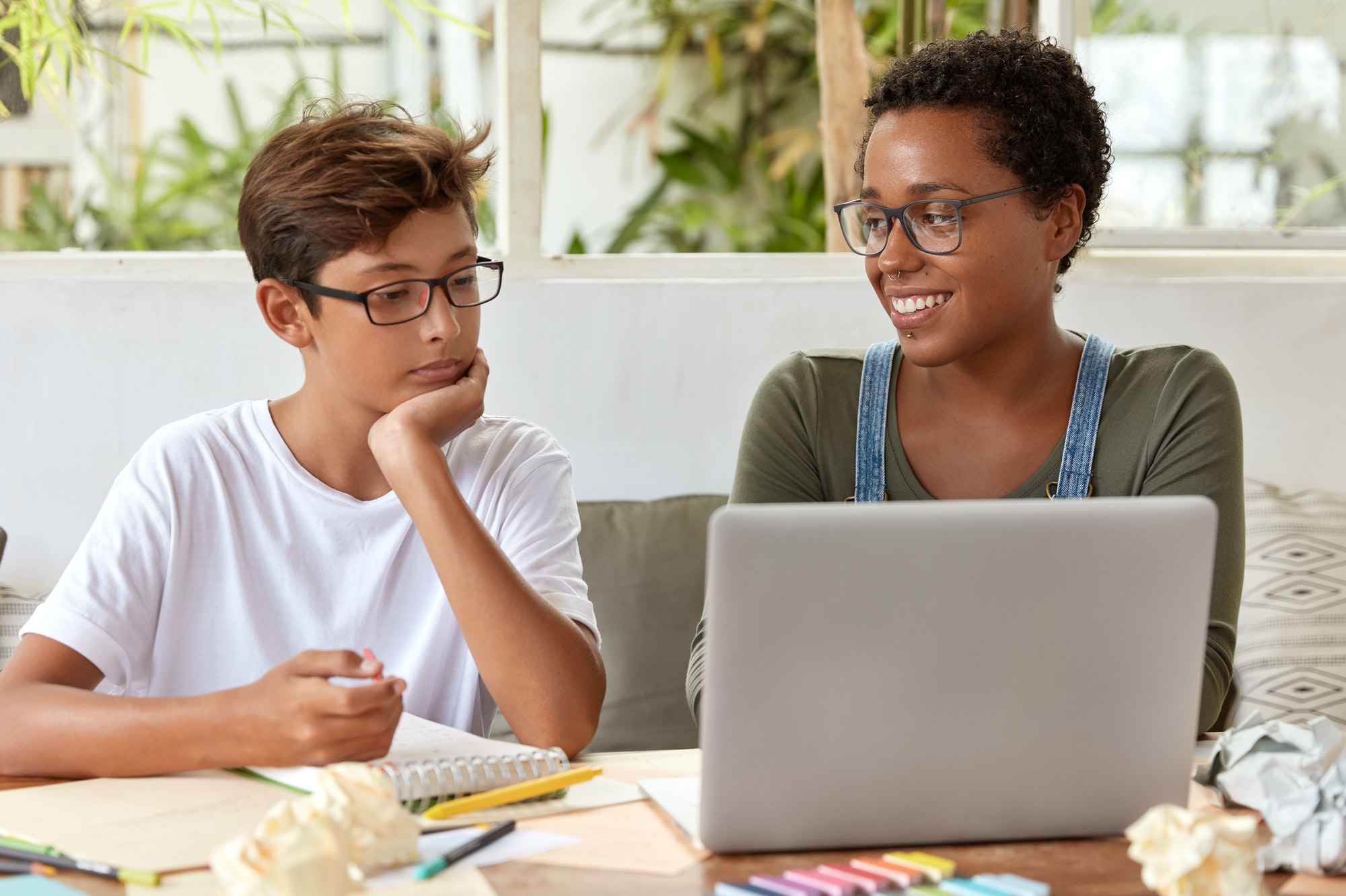 Self education and e learning concept. Satisfied black female volunteer tries to explain her strateg